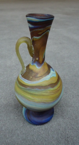 Tan and blue long
                  neck vase with handle 6 1/4"