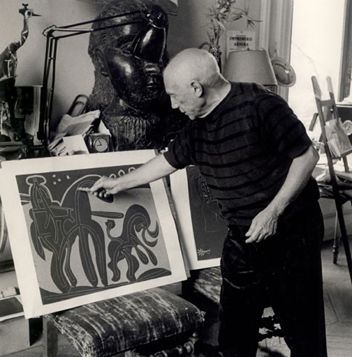 Picasso with
                  linocut, 1959