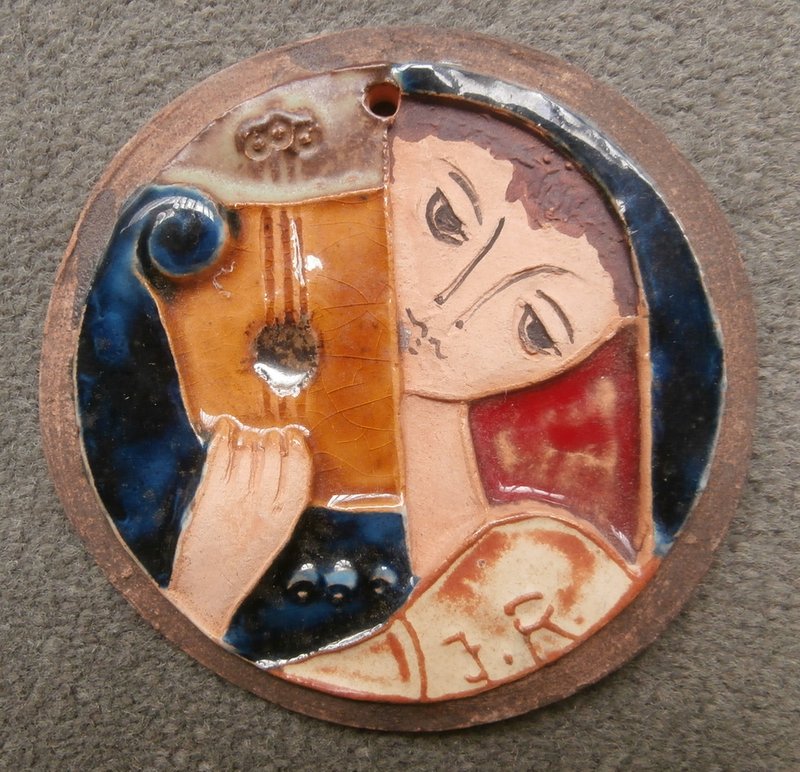 Figure with instrument round